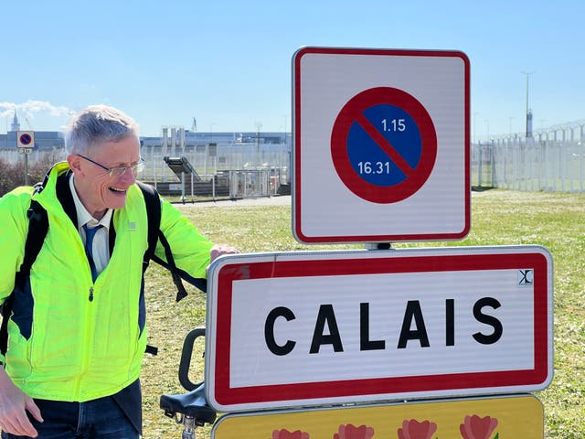 <p>Journey’s end: Simon Calder at the entrance to Calais</p>