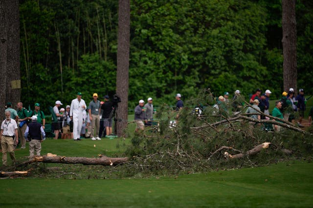 <p>Authorities investigate the scene where trees fell on the 17th hole during the second round of the Masters (Matt Slocum/AP)</p>