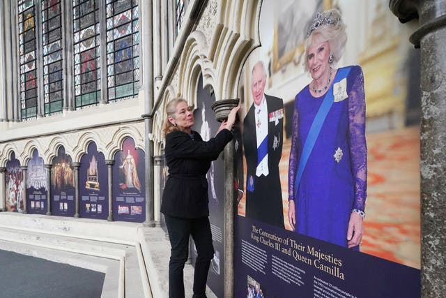 Abbey Curator Dr. Susan Jenkins makes final checks to a coronation exhibition in Westminster Abbey’s medieval Chapter House. The exhibition opens on April 8, 2023, and uses historic illustrations and archive photography to reveal elements of the coronation service. Picture date: Thursday April 6, 2023.