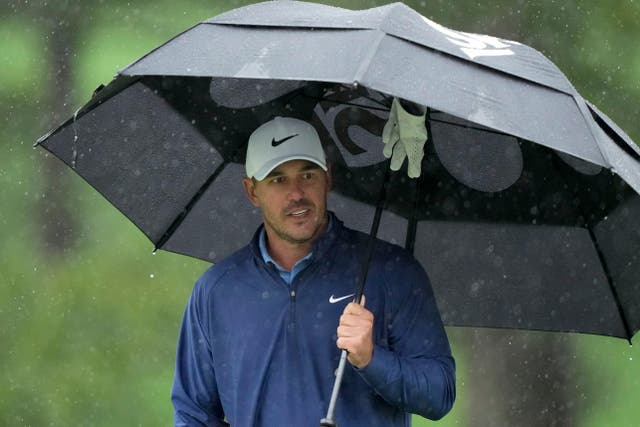 Brooks Koepka waits to play on the seventh hole moments before play was suspended in the 87th Masters (David J. Phillip/AP)