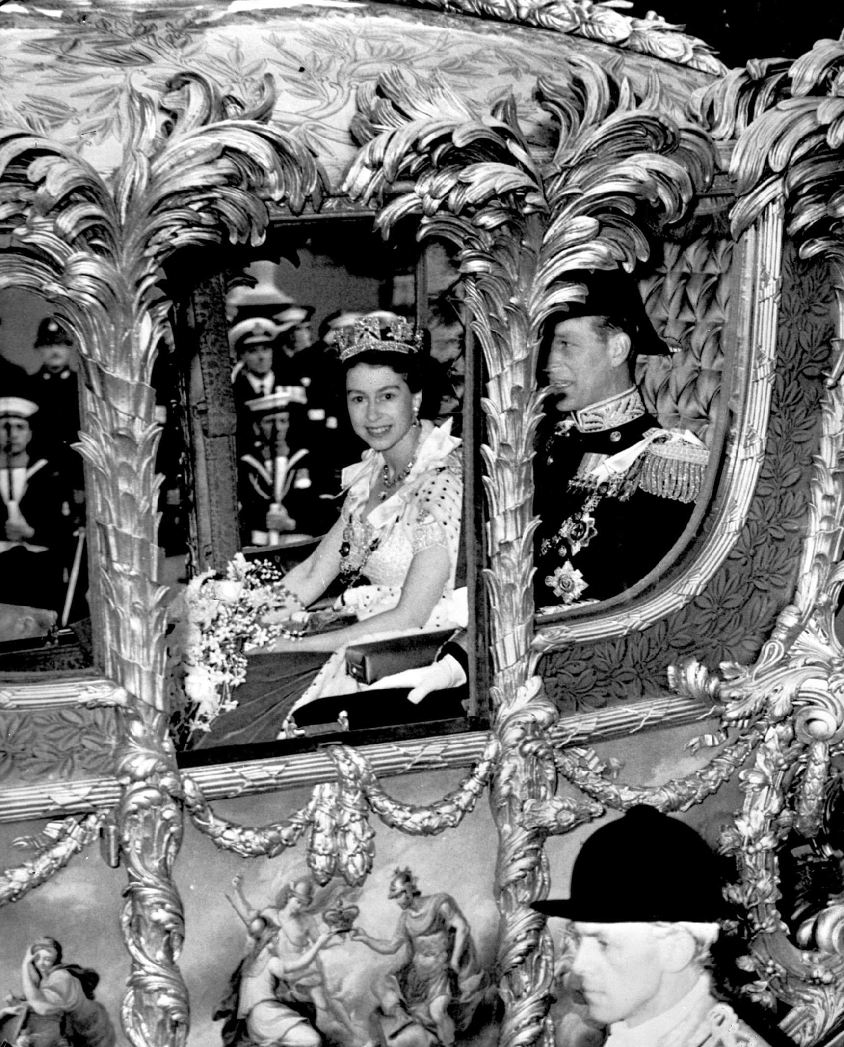 Queen Elizabeth II, accompanied by the Duke Of Edinburgh, in the Gold State Coach as it neared Trafalgar Square on the route to Westminster for her Coronation