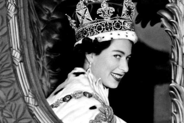 Queen Elizabeth II gives a wide smile for the crowd from her carriage as she leaves Westminster Abbey, London after her Coronation.