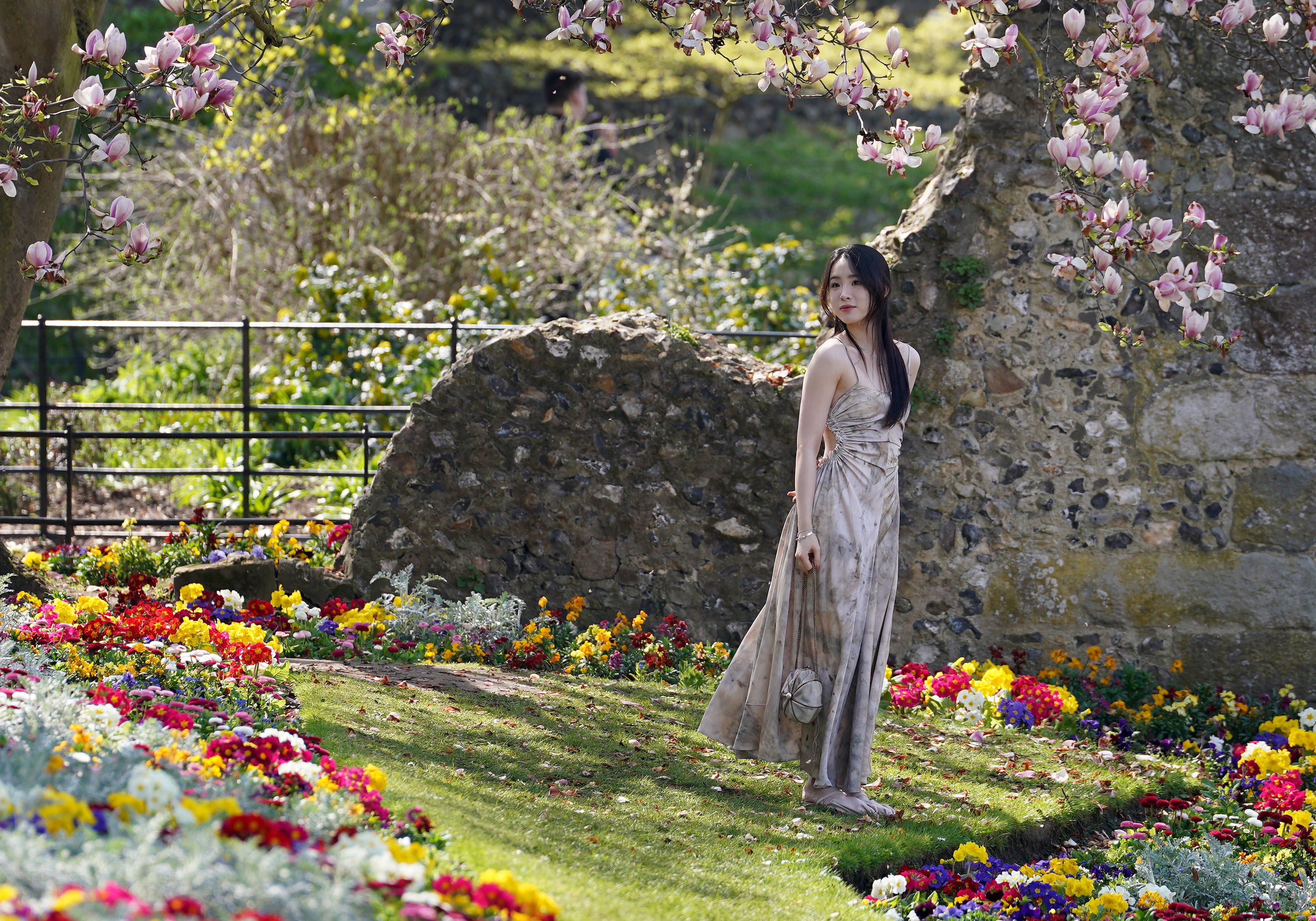 A tourist poses for pictures in Westgate Gardens, Canterbury