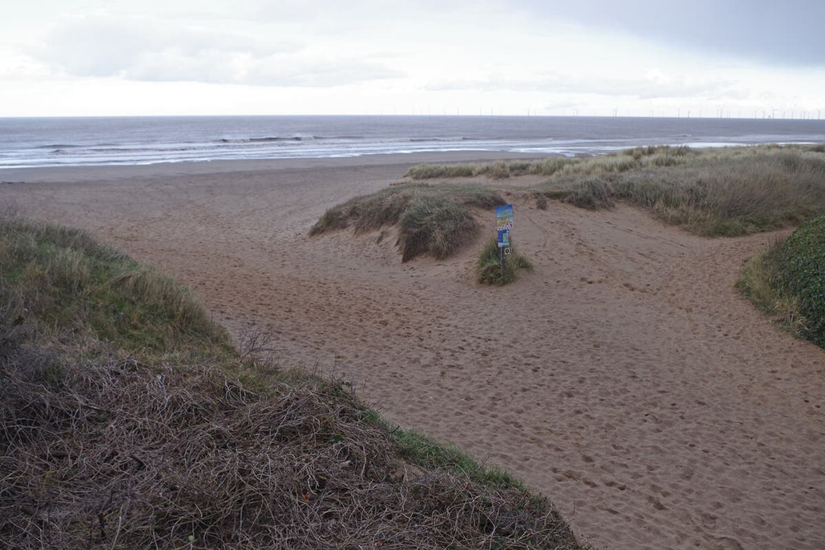 Boy nearly buried alive after beach hole collapse, rescuer says