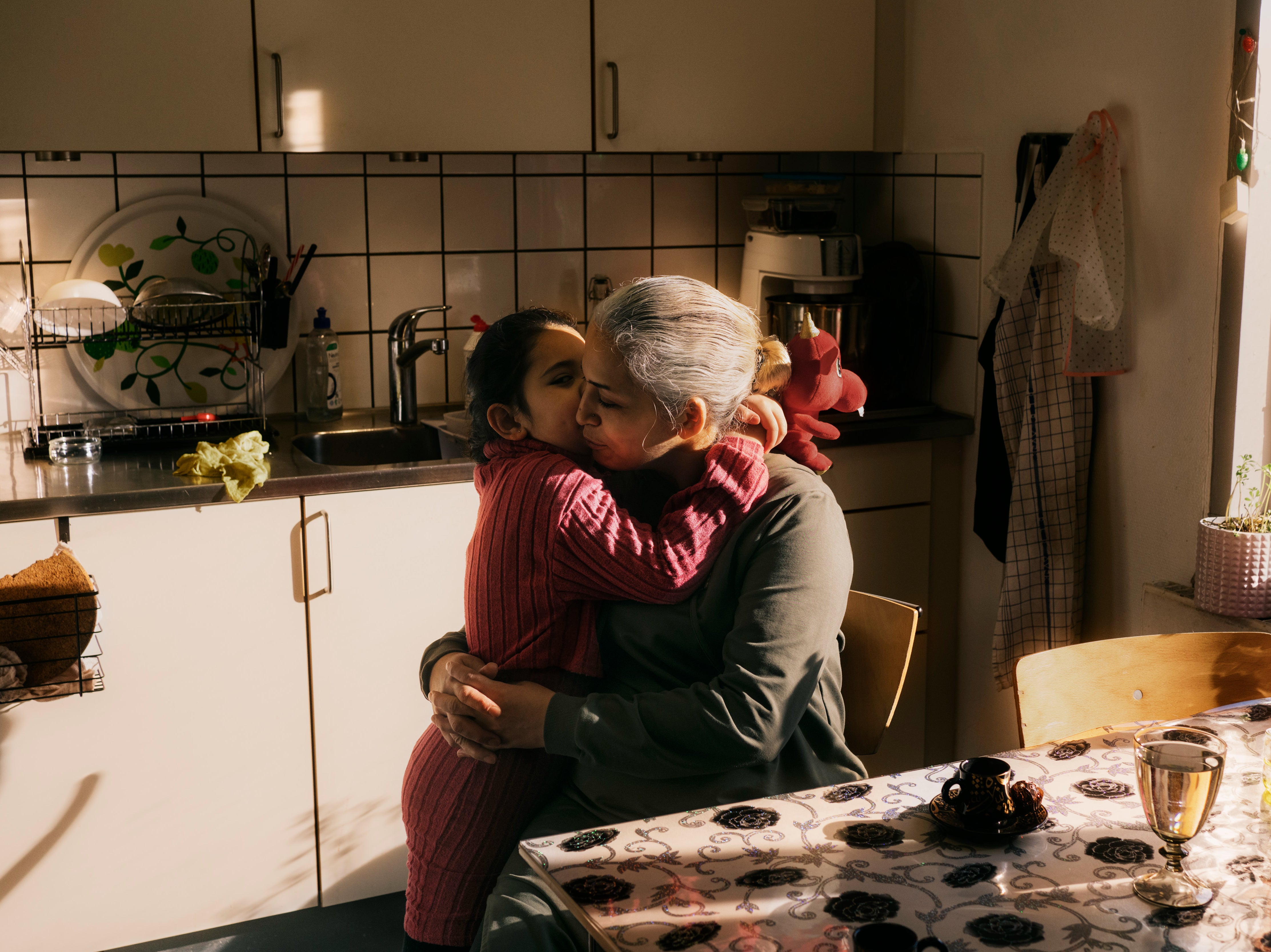 Yasmin Nasri hugs her daughter Lana before walking her to school in Jelling