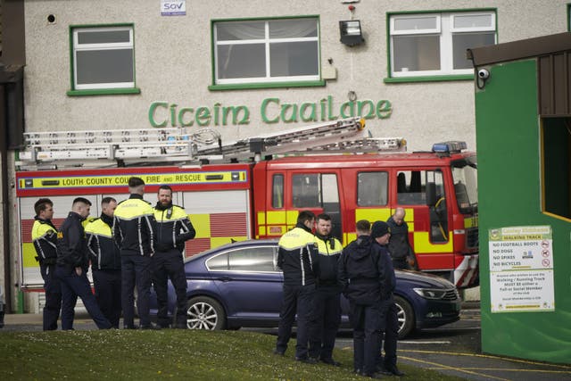 Members of the fire service and fardai begin preparations at Cooley Kickhams GAA Club, Co Louth (Niall Carson/PA)