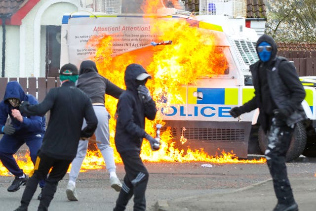 <p>Masked youths attack a Police landrover with petrol bombs  after Republicans took part in a march to commemorate the 1916 Easter Rising</p>