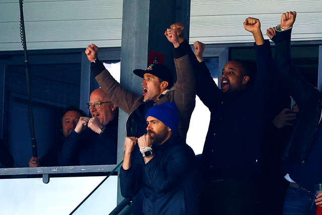<p>Ryan Reynolds, front, and co-owner Rob McElhenney celebrate Wrexham’s victory</p>