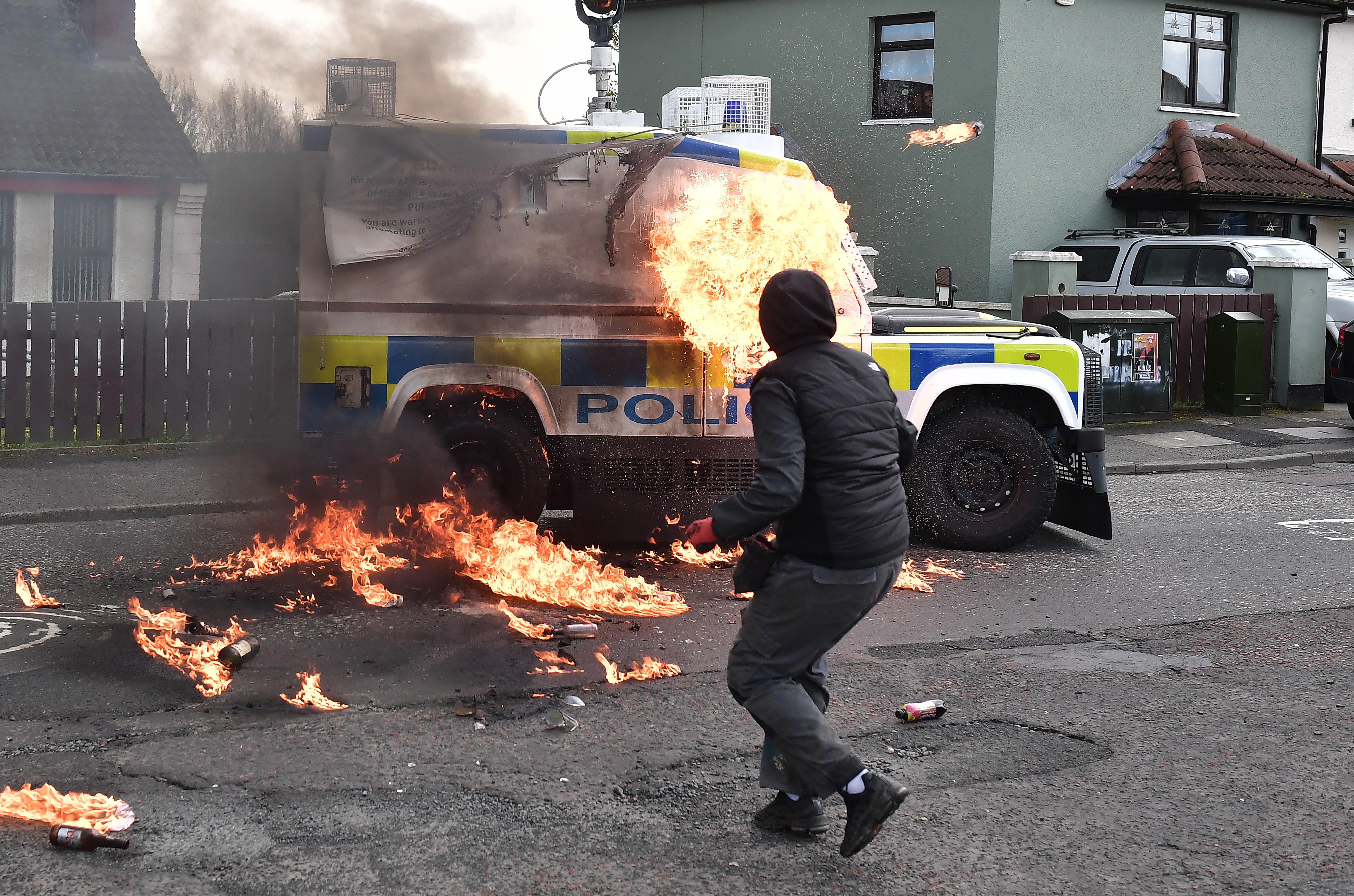 A police vehicle is attacked with petrol bombs during an illegal dissident march in Londonderry in April