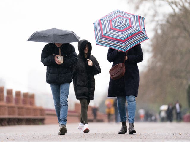 <p>People brave the rainy conditions in Battersea Park, London, on Easter on Monday</p>