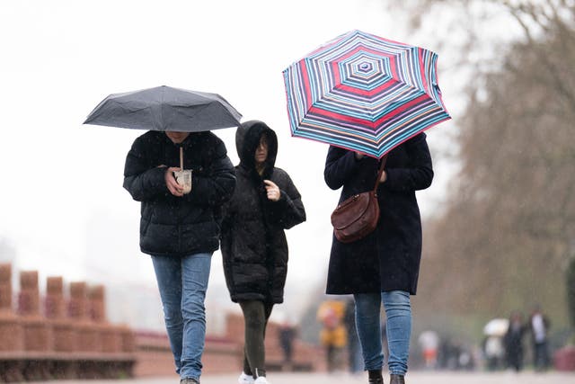 <p>People brave the rainy conditions in Battersea Park, London, on Easter on Monday</p>