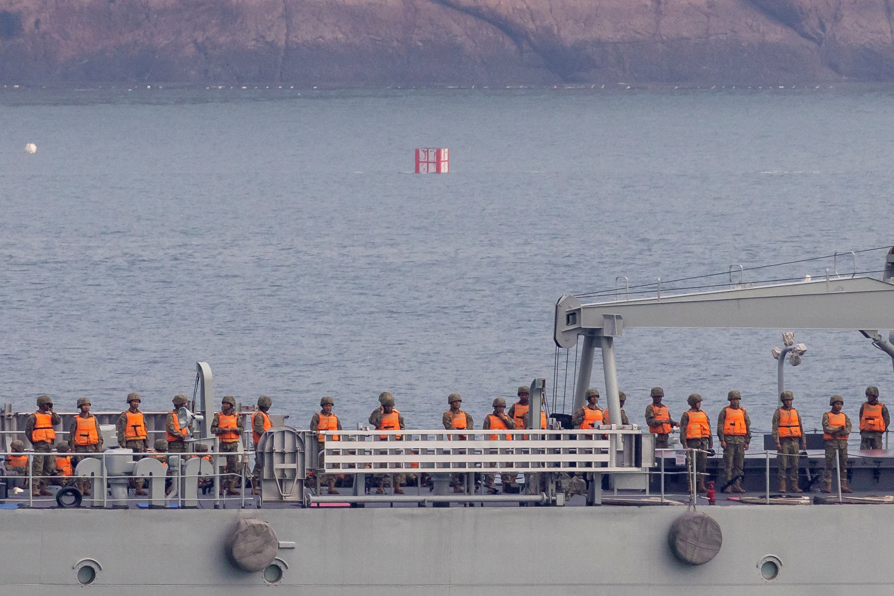 Chinese soldiers stand on deck as their warship takes part in a military drill off the Chinese coast near Fuzhou