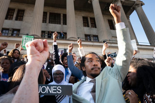<p>Rep Justin Jones raising his fist amid a crowd of supporters in Nashville </p>