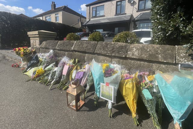 Floral tributes left outside a house on Hemper Lane, Greenhill, Sheffield (PA)