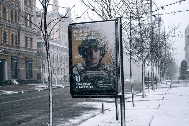 <p>A Ukrainian armed forces mobilisation campaign poster in Kyiv reads: ‘Unbreakable, unconquered, unstoppable’ </p>