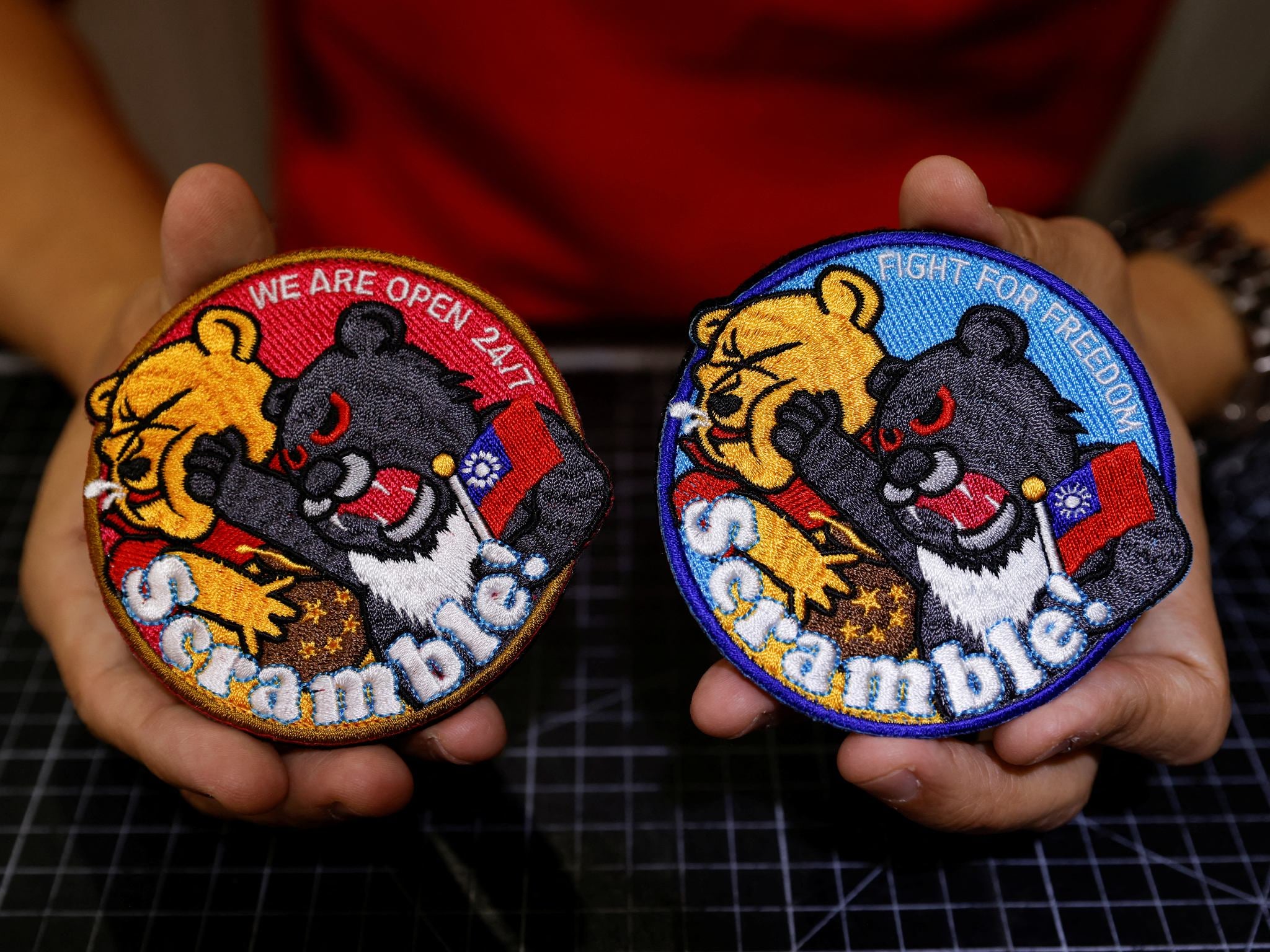 Alec Hsu with the patches depicting a Formosan black bear holding Taiwan’s flag and punching Winnie-the-Pooh