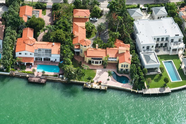 <p>Aerial view of a row of villas - each with a swimming pool - in Miami, Florida</p>