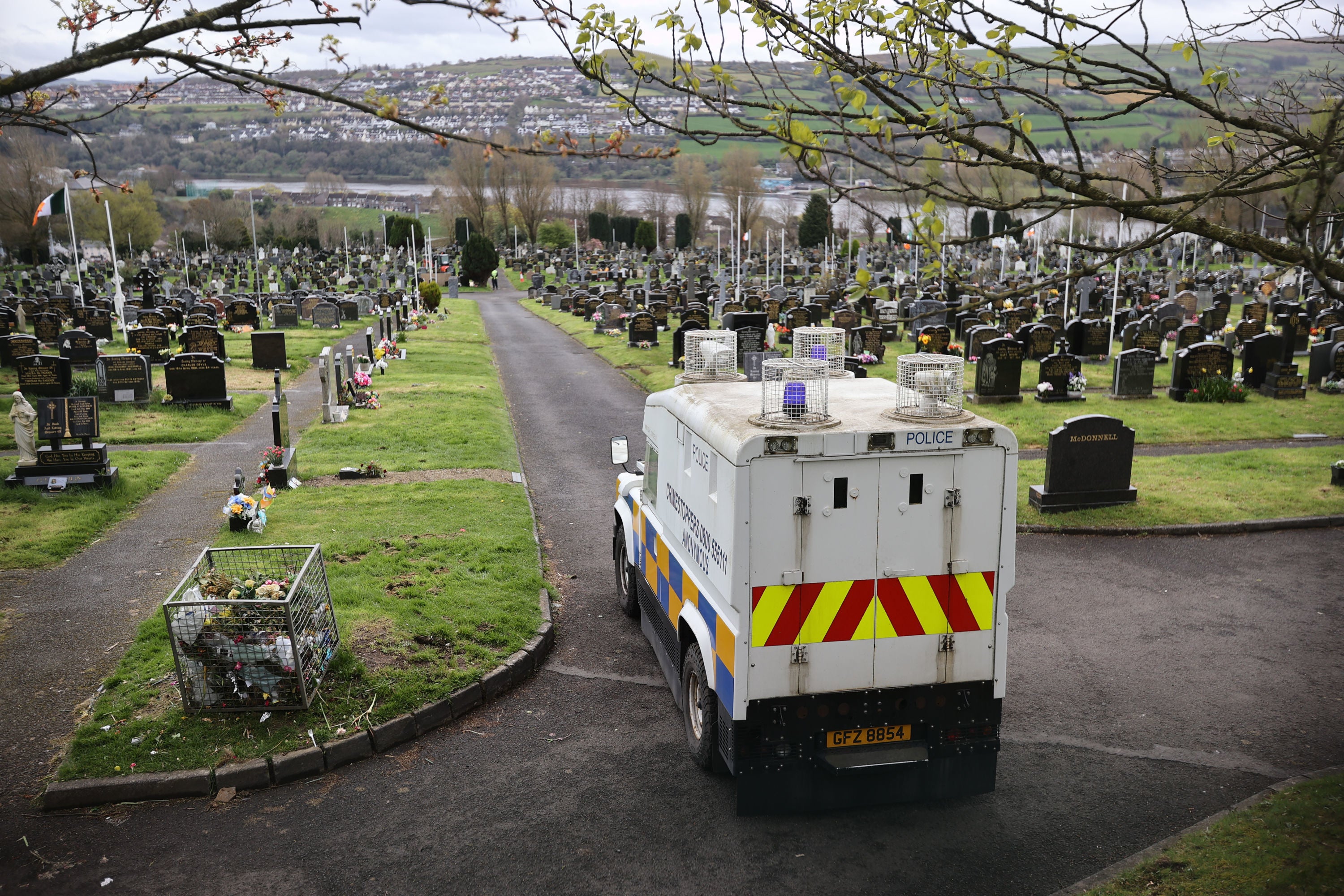 A PSNI vehicle inside Derry City Cemetery, as Army Technical Officers check for devices