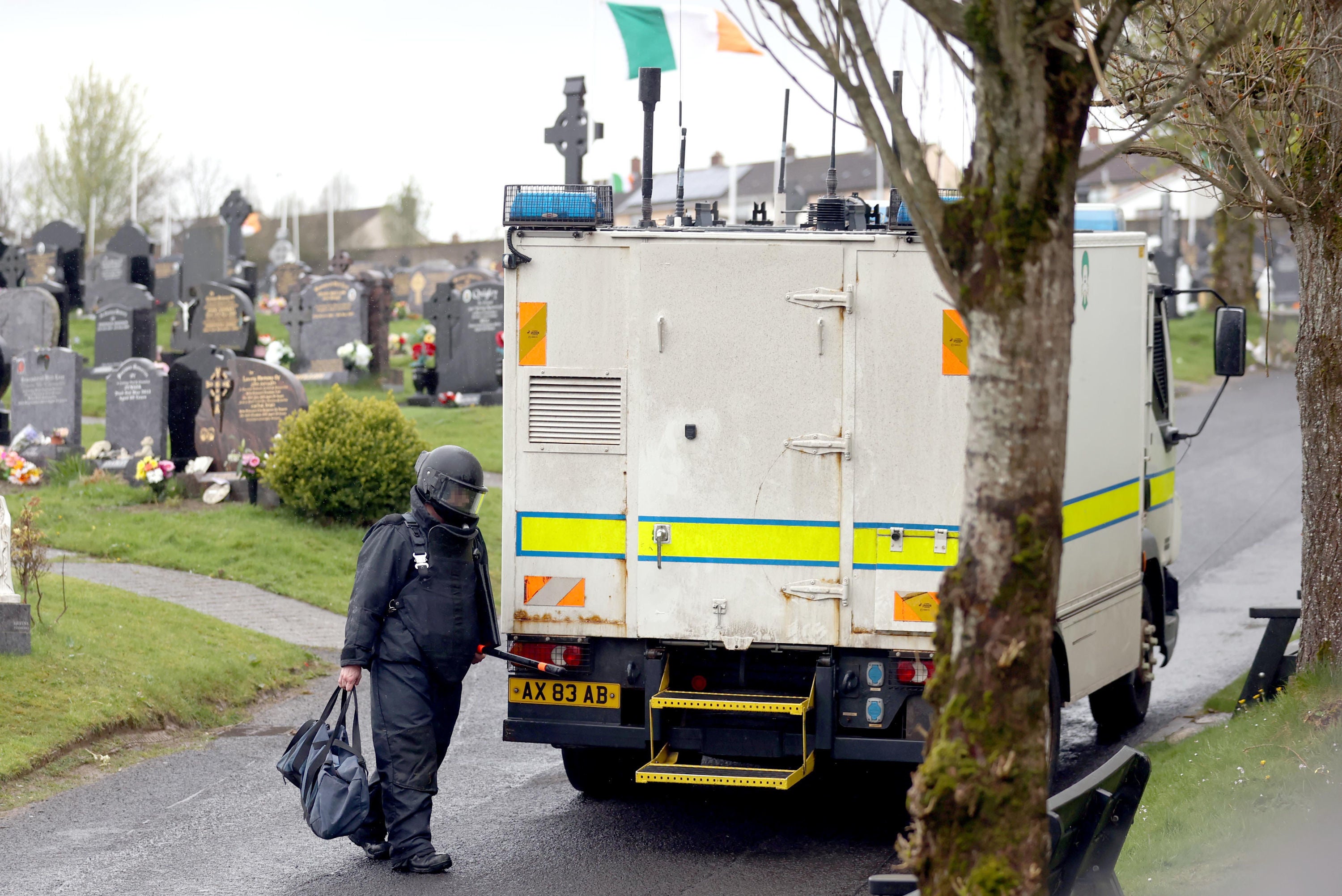 An Army Technical Officer returns to his vehicle during a search at Derry City Cemetery