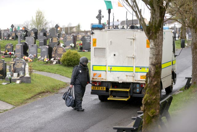 An Army Technical Officer returns to his vehicle at Derry City Cemetery during a security operation (Liam McBurney/PA)