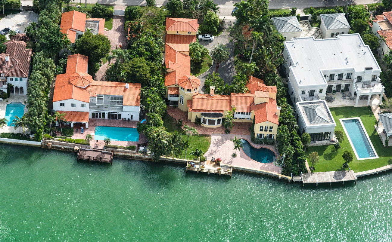 Aerial view of a row of villas - each with a swimming pool - in Miami, Florida