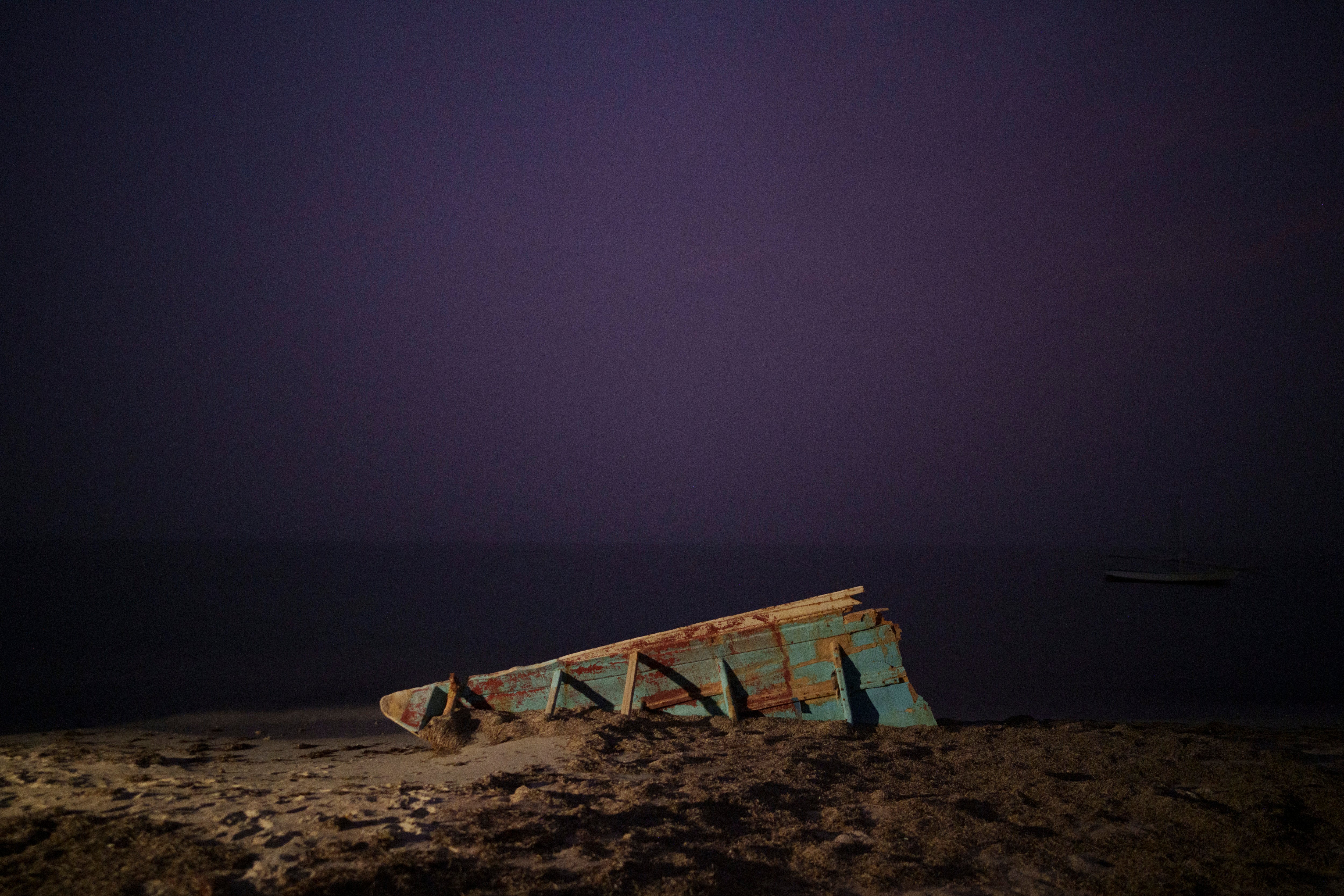 File. The wreck of a traditional Mauritanian fishing boat, known as a pirogue, also used by migrants to reach Spain’s Canary Islands, sits on a beach near Nouadhibou, Mauritania, Thursday, 2 December 2021