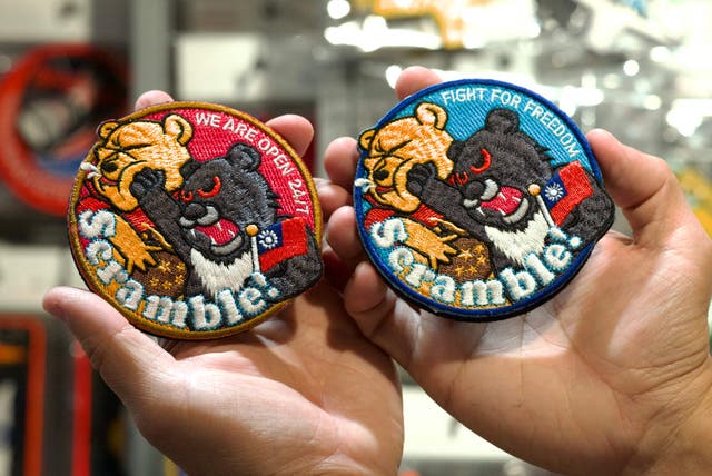 <p>This picture shows patches depicting a Formosan black bear holding a Taiwanese flag punching Winnie-the-Pooh at a shop in Taoyuan</p>