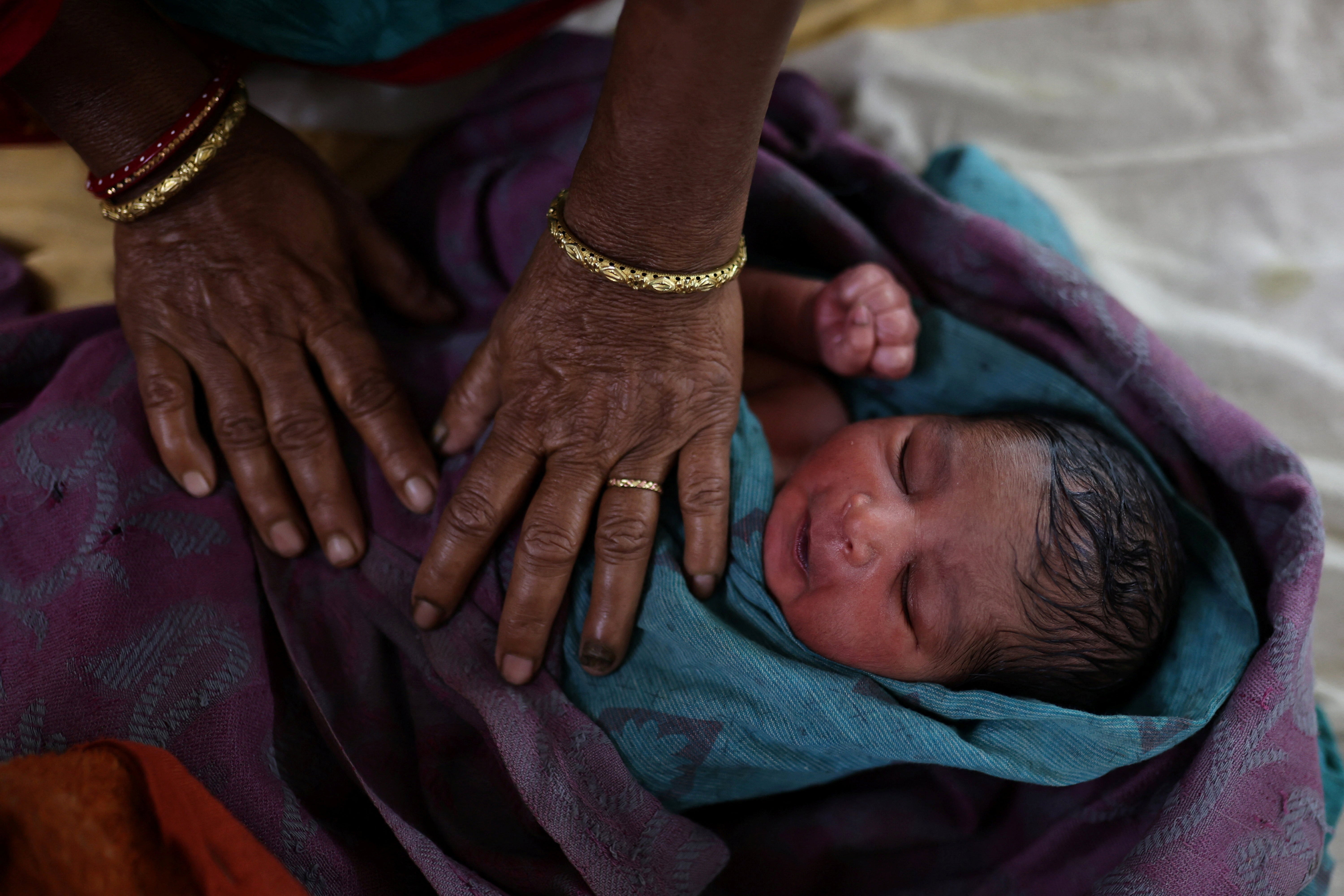 A nurse takes care of a newborn baby at a hospital in Kishanganj district