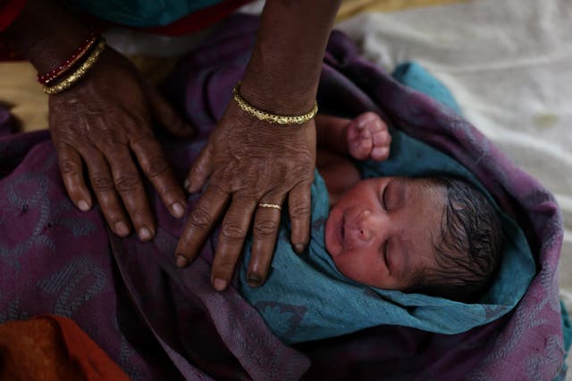 <p>File: A nurse takes care of a newborn baby after the birth at a hospital in Kishanganj district, Bihar, India</p>