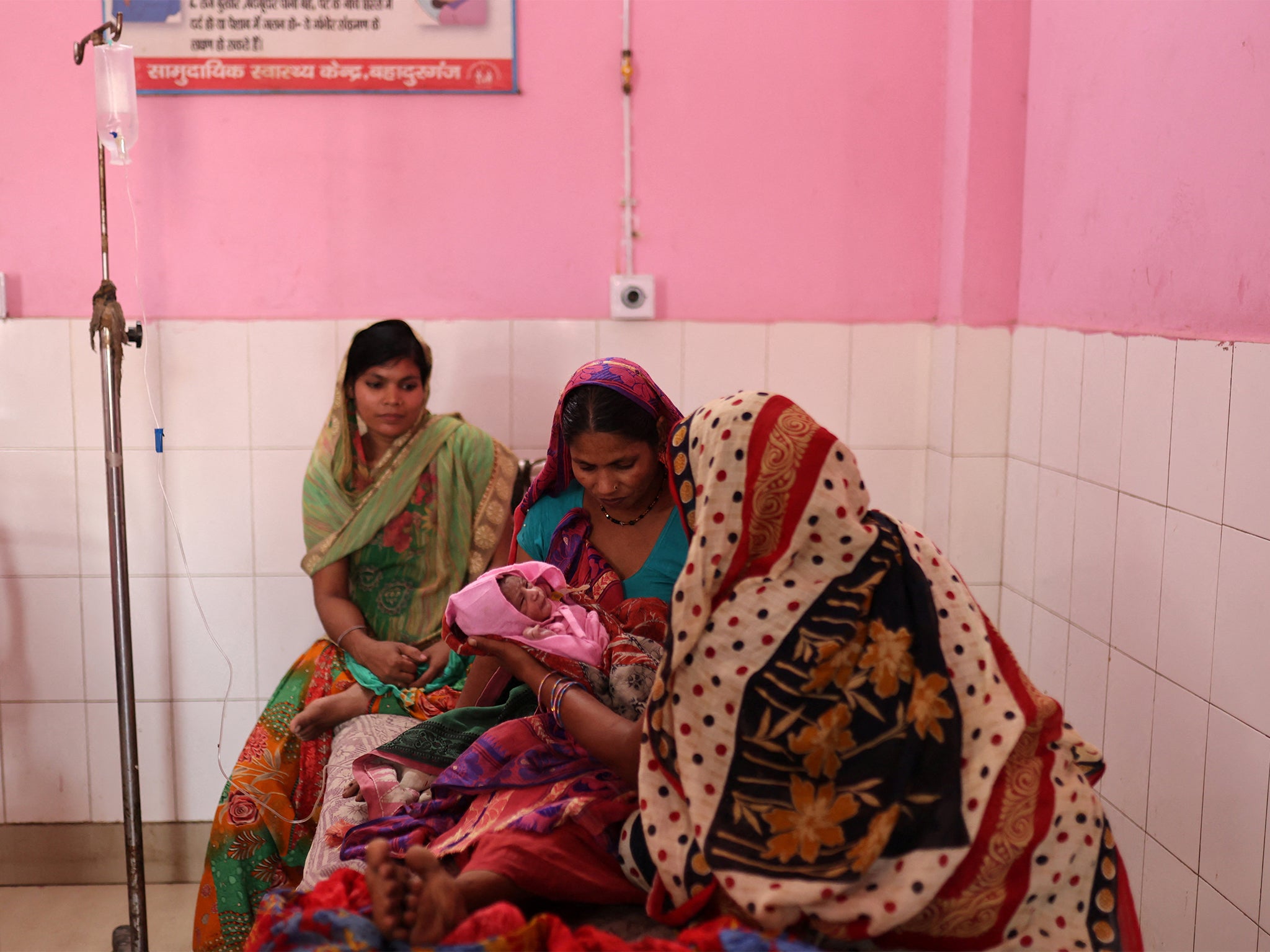 Zamerun Nisha, 33, holds her newborn baby on the maternity ward of a community health centre in the state of Bihar, India