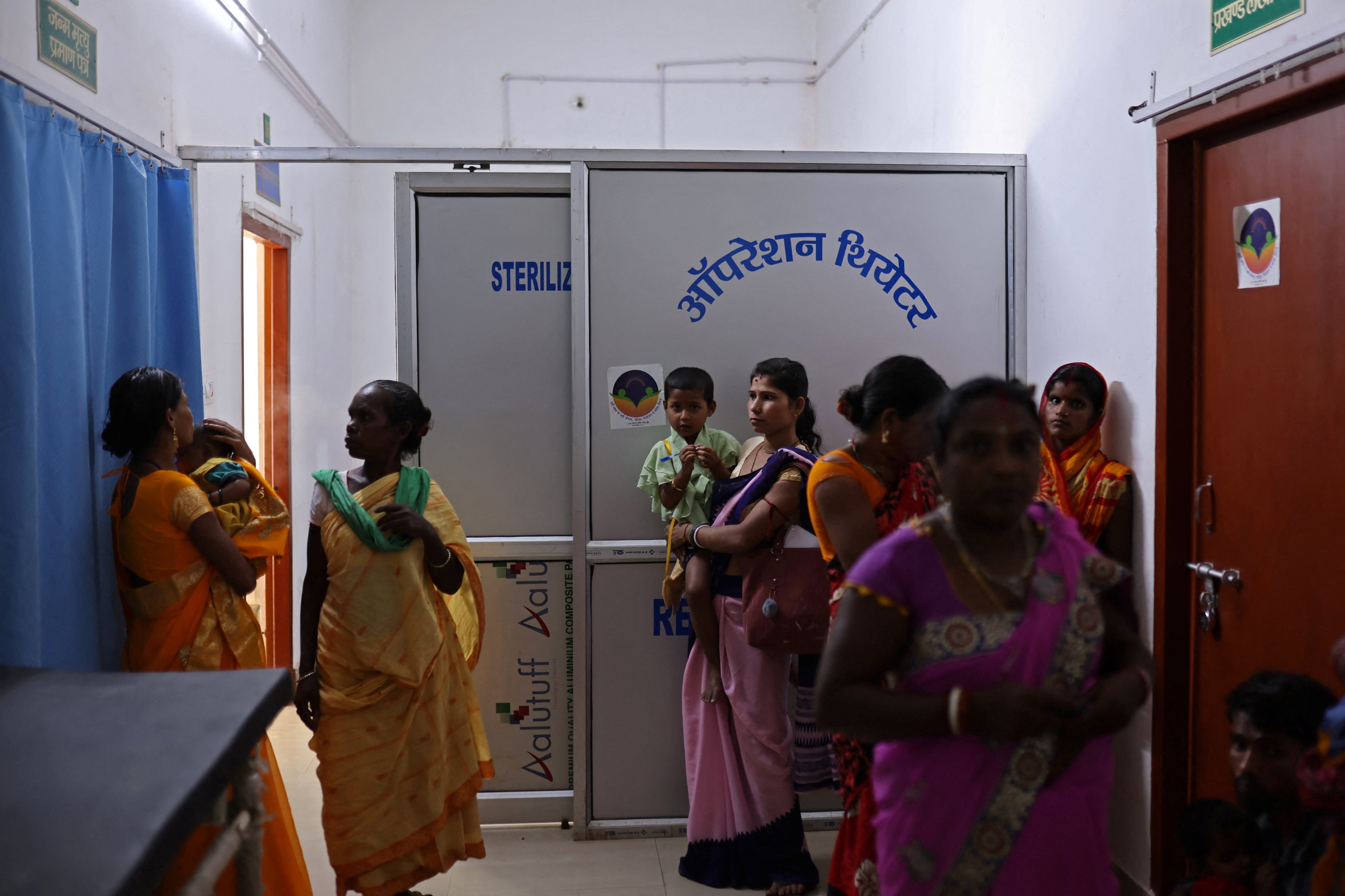 Women wait outside the operating theatre in a community health centre in Kishanganj