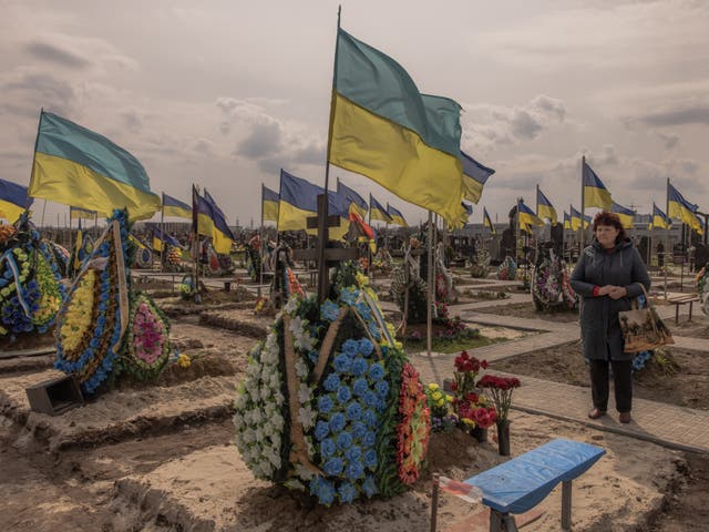 <p>A woman visits the part of a cemetery where Ukrainian soldiers are buried, on April 11, 2023 in Brovary, Ukraine</p>