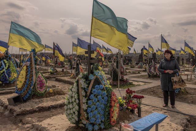 <p>A woman visits the part of a cemetery where Ukrainian soldiers are buried, on April 11, 2023 in Brovary, Ukraine</p>