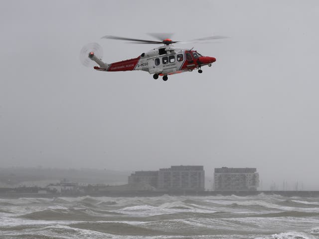 <p>A coastguard helicopter scours the rough sea off Brighton</p>