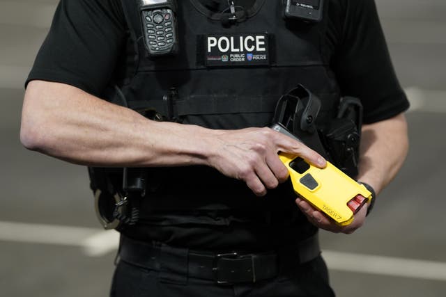 An officer demonstrates the Taser 7 as Hampshire and Thames Valley forces roll out of new device (Andrew Matthews/PA)