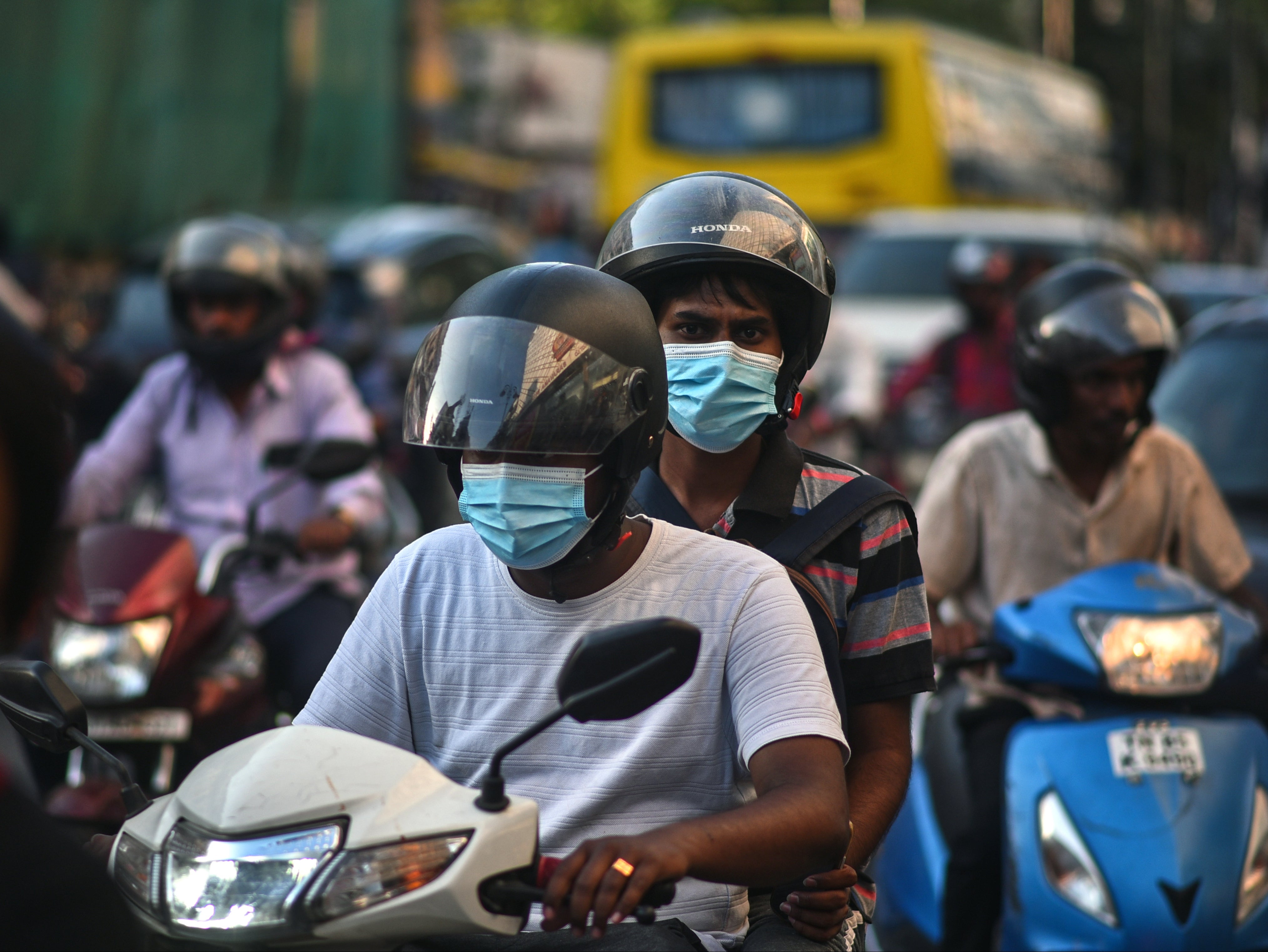 Commuters wear face masks amidst the spike in Covid cases in Chennai, India