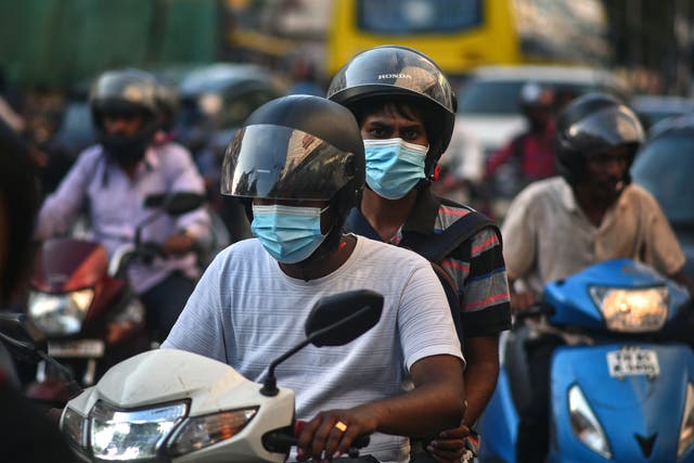 <p>Commuters wear face masks amidst the spike in Covid cases in Chennai, India, on 11 April 2023</p>