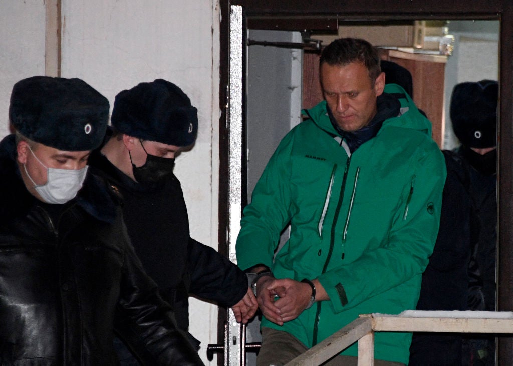 Russian oppposition leader Alexei Navalny is escorted out of a police station in 2021, after being sentenced to jail.