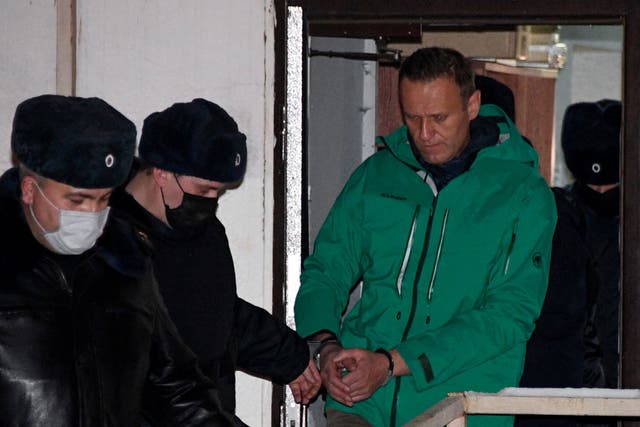 <p>Russian oppposition leader Alexei Navalny is escorted out of a police station in 2021, after being sentenced to jail. </p>