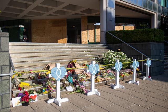<p>A makeshift memorial is set up on the steps of the Old National Bank, site of the 10 April 2023 shooting in Louisville, Kentucky, on 12 April 2023</p>