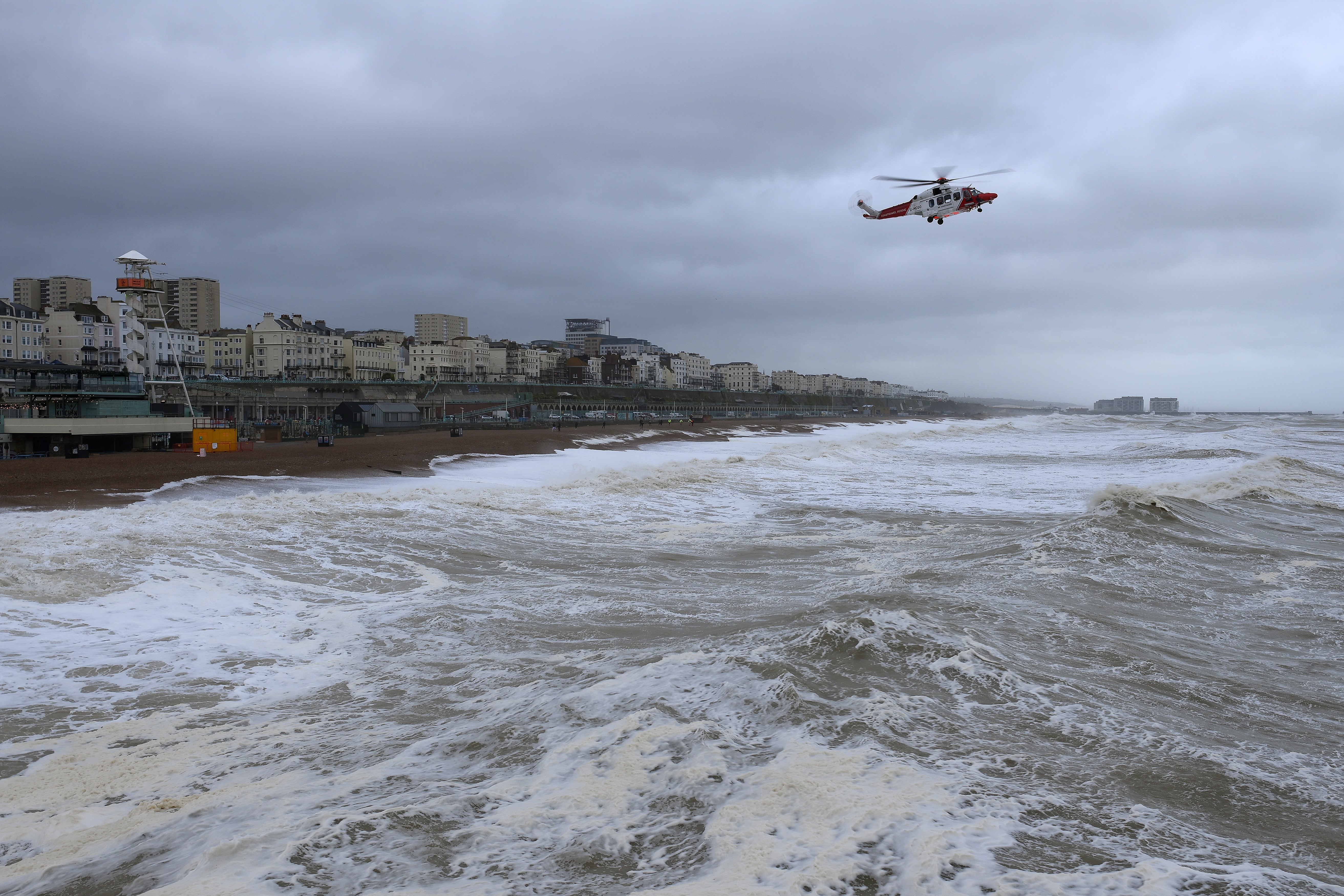 A coastguard helicopter scours the rough sea off the Brighton coast on Wednesday