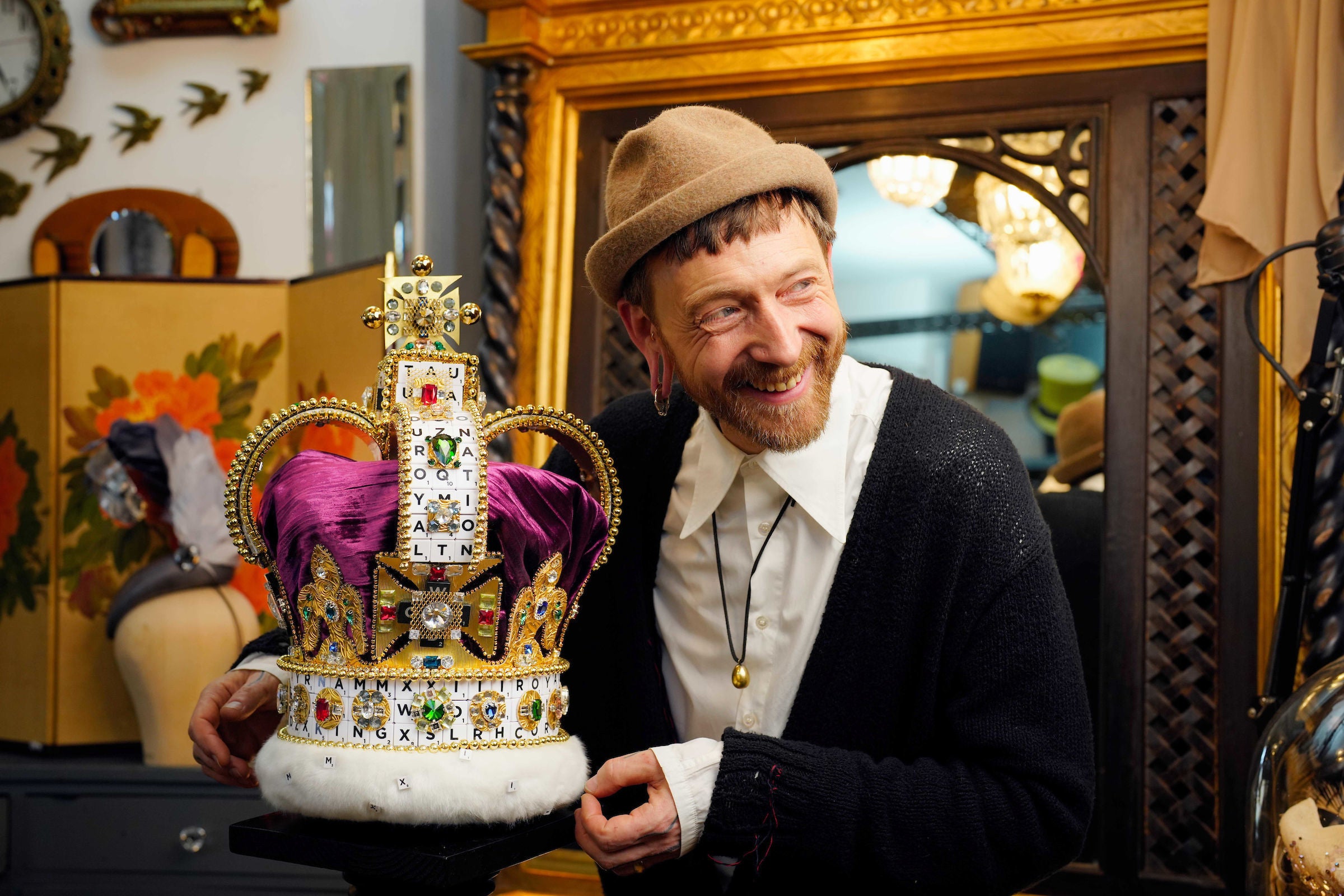 British milliner Justin Smith with a crown he has created using 319 Scrabble tiles