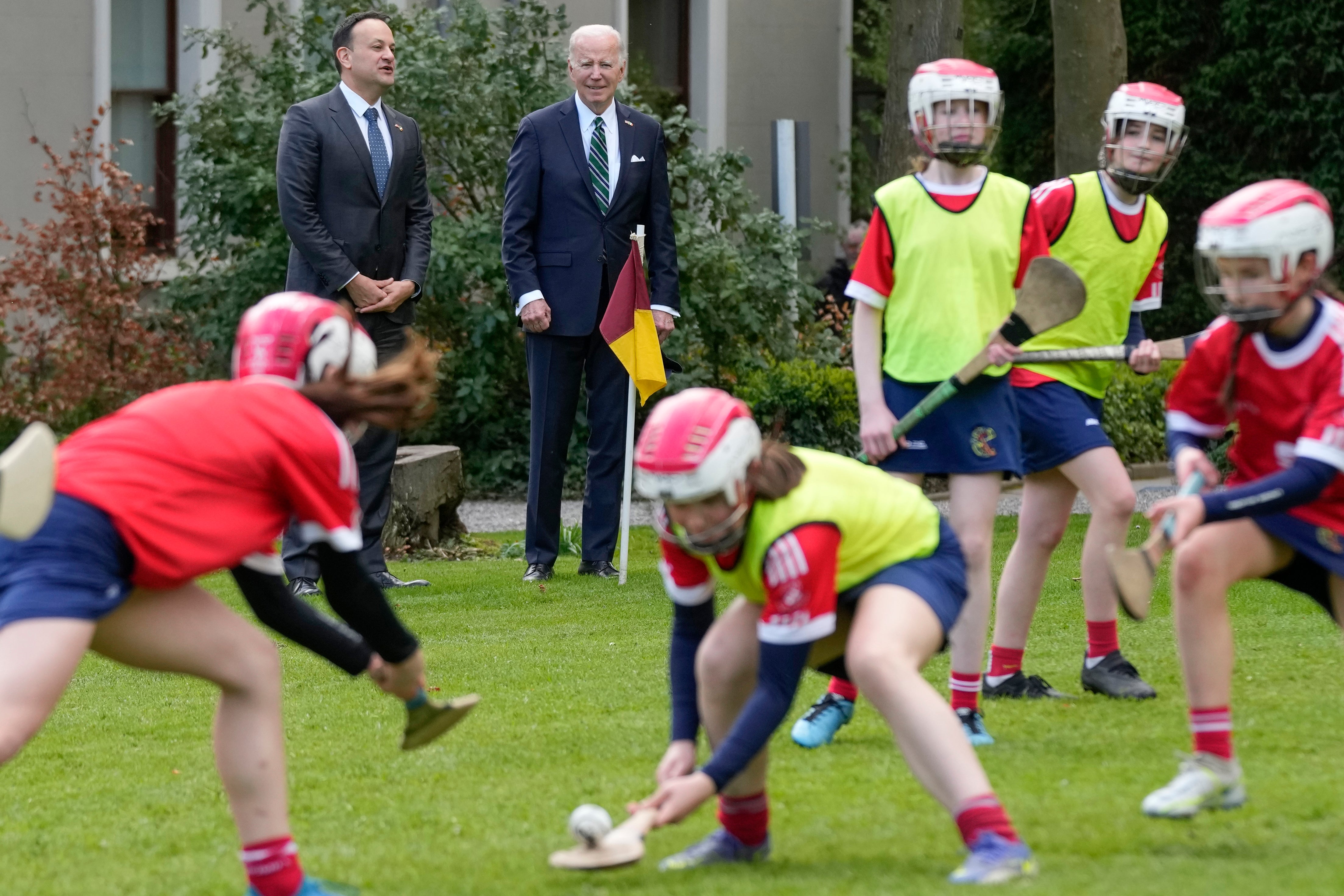 President Joe Biden and Ireland's Taoiseach Leo Varadkar watch as girls play hurling during a youth Gaelic sports demonstration at Farmleigh House,