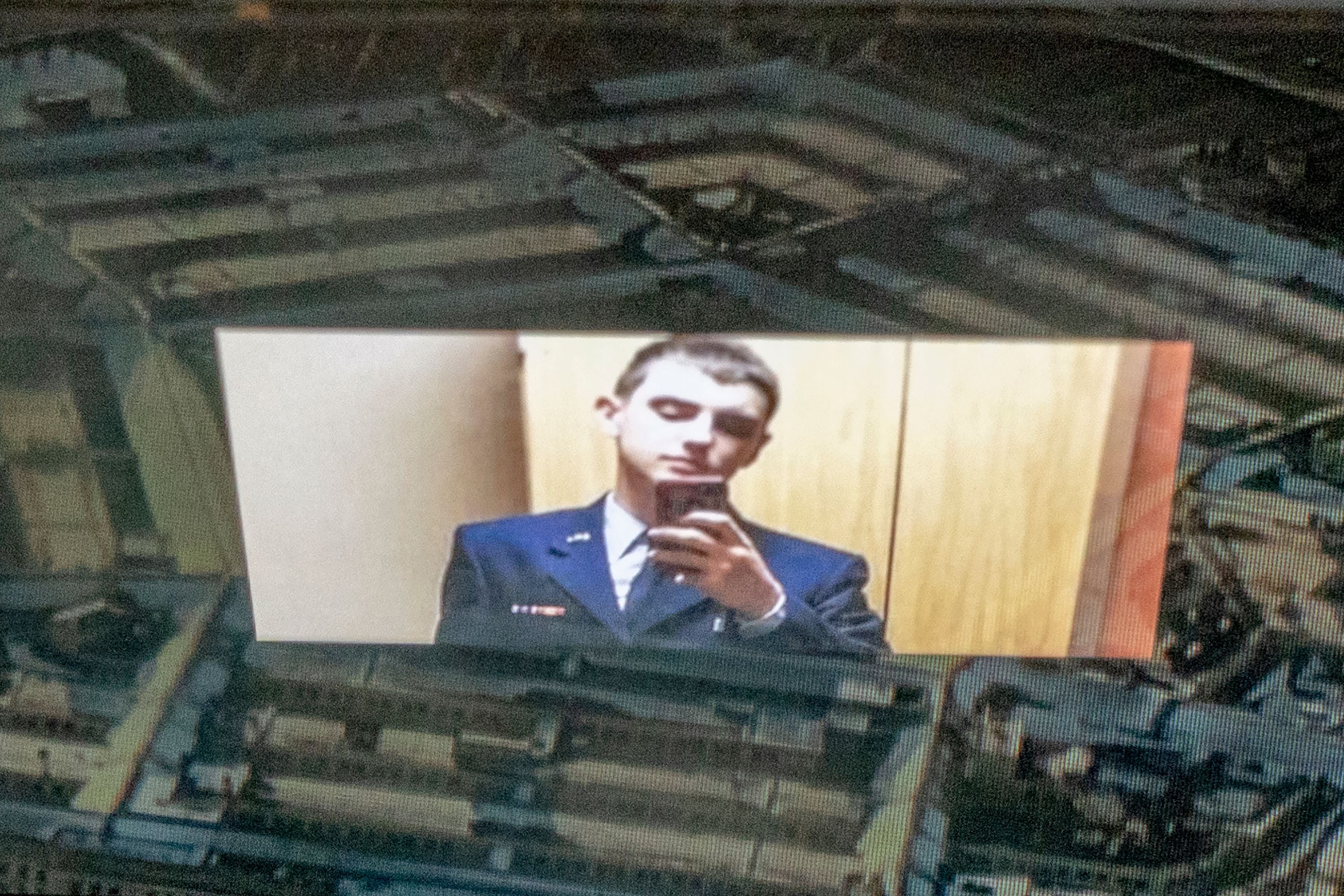 This photo illustration shows the suspect, national guardsman Jack Teixeira, reflected in an image of the Pentagon