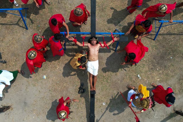 <p>Ruben Enaje is nailed to the cross during a reenactment of Jesus Christ’s sufferings as part of Good Friday rituals </p>