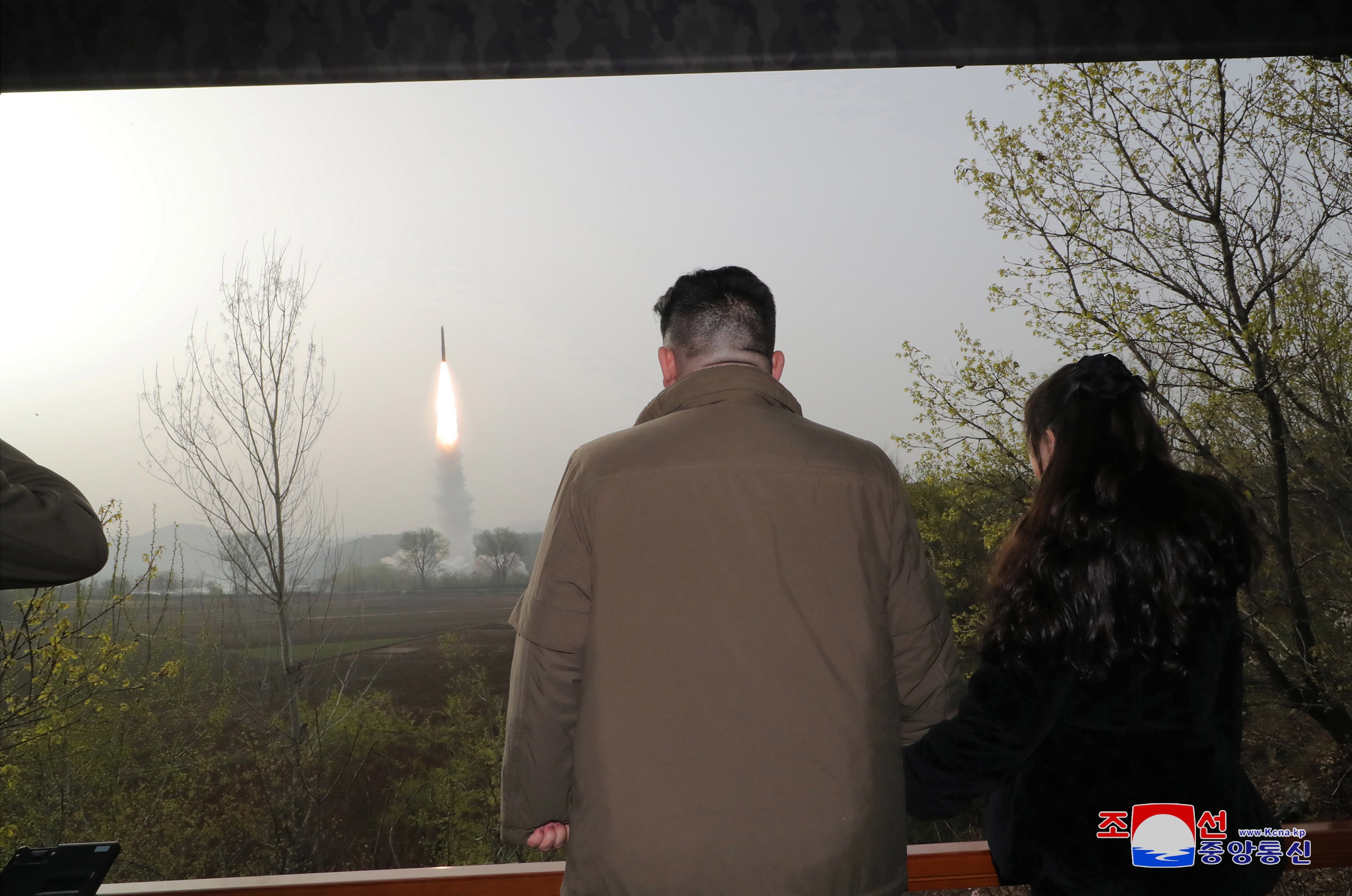 North Korean leader Kim Jong Un (left) and his daughter Kim Ju Ae observing the test firing of a new solid-fuel Hwasong-18 ICBM at an undisclosed location in North Korea on 13 April 2023