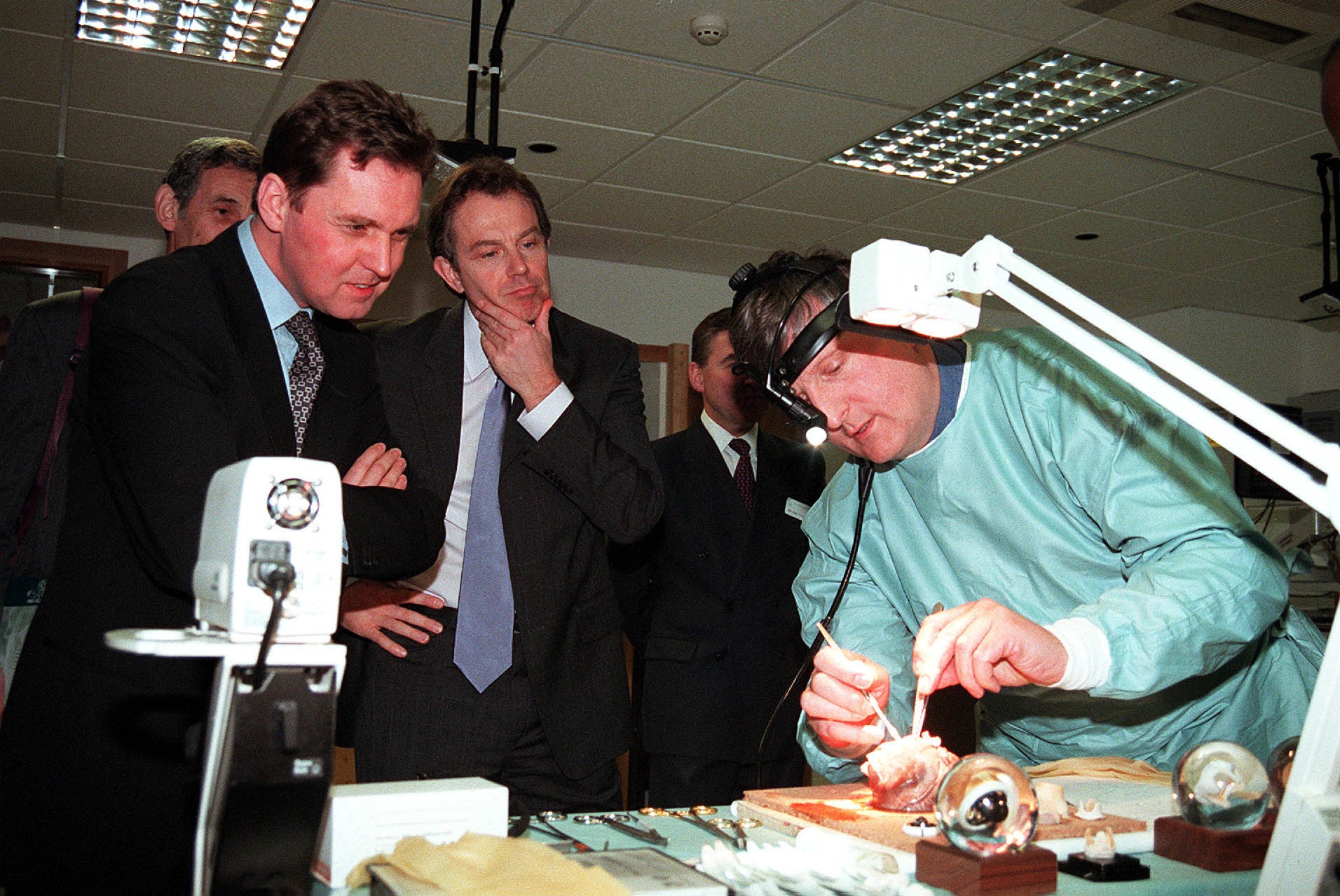 Milburn, left, and Blair watch aortic root surgery on a pigs heart performed by Professor John Pepper of the Royal Brompton Hospital in 2000