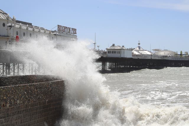 A view of waves crashing near the pier in Brighton (Gareth Fuller/PA)