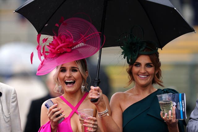 Race goers brave the weather during day two of the Randox Grand National Festival(David Davies for The Jockey Club/PA)