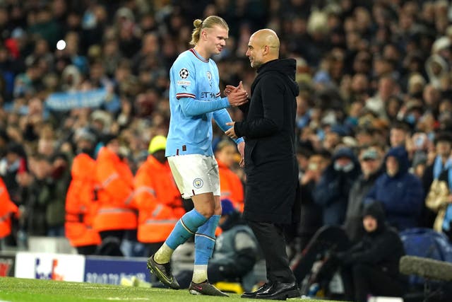 Manchester City’s Erling Haaland, left, with Pep Guardiola (Martin Rickett/PA)